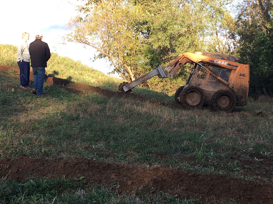 Digging the drainage tile and conduit trenches